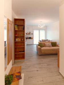 a living room with a couch and a table at Assisi valley - Modern Apartment with Covered Parking in Bastia Umbra +10 photos