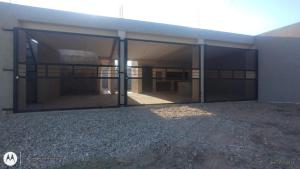a large garage with sliding glass doors on a building at Lihuel 1 AG in Alta Gracia