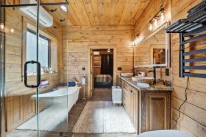 a bathroom with a tub and a sink at Raka Ranch Barndominium in Folsom +33 photos