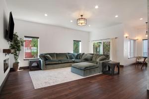 a living room with a couch and a table at Beautiful new home in Sanders Beach! in Coeur d'Alene