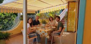 a group of people sitting around a table on a patio at Alloggio vacanza di Michele in Casamicciola Terme