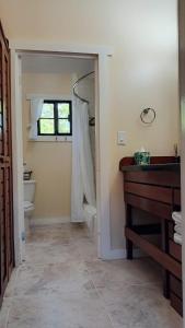 a bathroom with a sink and a toilet and a window at Santa Cruz Cabins in Santa Elena +59 photos