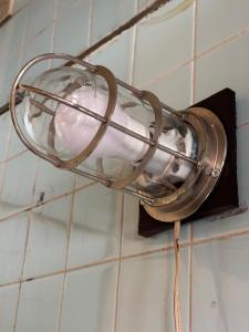 a light attached to a wall with a wire at LAKE FOREST hug pug in Yamanakako