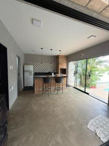 an open kitchen and living room with a large sliding glass door at Hostel Casa do Sossego in Brasília