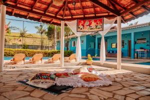 a bed on a patio next to a pool at Pousada Vilarejo de Minas in Itapeva