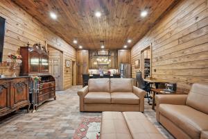 a living room with a couch and a table at Raka Ranch Barndominium in Folsom