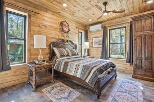 a bedroom with a bed in a room with wooden walls at Raka Ranch Barndominium in Folsom