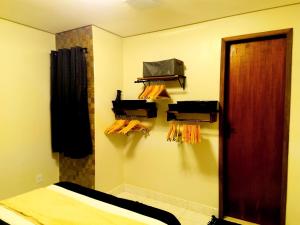 a room with a bed and a mirror and a door at Tiny House, Refúgio Aconchegante em Mucugê in Mucugê +21 photos