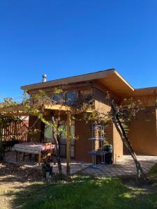 a house with a pergola in the yard at Rancho Elquino in Vicuña