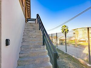 a staircase leading up to a building with a fence at L'écrin d'Amaroa in Fort-de-France