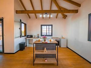 a kitchen with a table in the middle of a room at L'écrin d'Amaroa in Fort-de-France