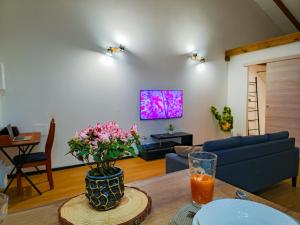 a living room with a vase of flowers on a table at L'écrin d'Amaroa in Fort-de-France