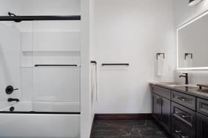 a bathroom with a shower and a sink at Beautiful new home in Sanders Beach! in Coeur d'Alene +38 photos