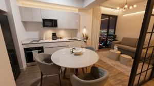 a kitchen and living room with a table and chairs at Deluxe Studio in Secrt Escalante AC in San Pedro