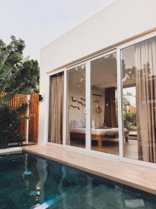 a house with a swimming pool and a bedroom at Villa Nindot - Private pool villas - Adults only in Siquijor