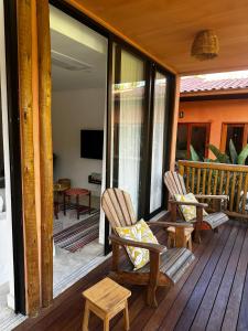 two chairs on the porch of a house at Vila Anambé in Uruçuca