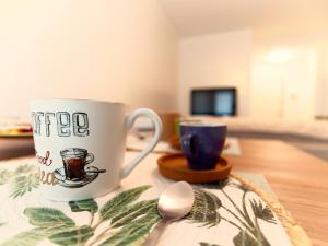 a coffee cup sitting on top of a table at Assisi valley - Modern Apartment with Covered Parking in Bastia Umbra