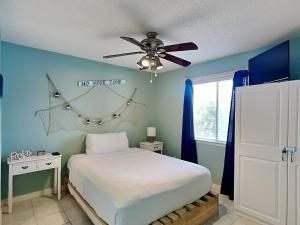 a bedroom with a bed and a ceiling fan at Island Home 102 in Destin