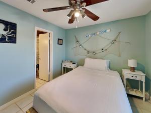 a bedroom with a bed and a ceiling fan at Island Home 102 in Destin +10 photos