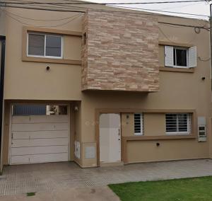 a house with two garage doors at Departamento juana con cochera in Rafaela