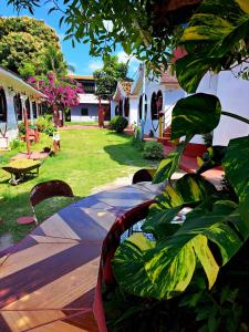 a table and chairs in a yard with a house at Pousada dos Corações in Salvaterra