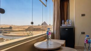 a bottle of water on a table in front of a window at Queen Cleopatra Boutique Hotel in Cairo