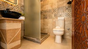 a bathroom with a toilet and a shower and a sink at Queen Cleopatra Boutique Hotel in Cairo +101 photos