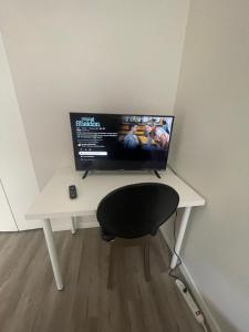 a desk with a computer monitor on top of it at Ron's Place in Saskatoon