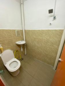 a bathroom with a toilet and a sink at Bertam Transit Homestay in Kampong Alor +6 photos