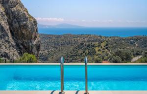 a swimming pool with a view of the ocean at Prinos 3 in Agia Galini