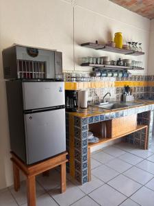 a kitchen with a white refrigerator and a sink at Casa Jardín in Tequila