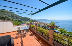 a balcony with a table and chairs and the ocean at Oleandri in Vietri sul Mare