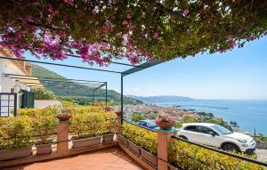 a white car parked on a balcony overlooking the water at Oleandri in Vietri sul Mare +13 photos