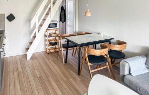 a living room with a dining room table and chairs at Gorgeous Apartment In Ringkøbing With Wifi in Ringkøbing