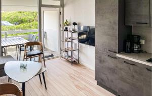 a kitchen and dining room with a table and a dining room at Gorgeous Apartment In Ringkøbing With Wifi in Ringkøbing