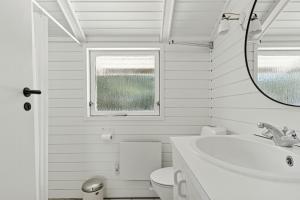 a bathroom with a sink and a toilet and a mirror at Experience Nature's Embrace And Peace in Græsted +31 photos