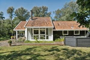 a house with a wooden deck in the yard at Experience Nature's Embrace And Peace in Græsted