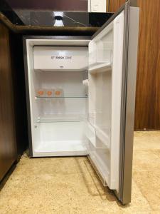 an empty refrigerator with its door open in a kitchen at Muunyal Naj in Valladolid