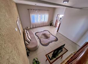 an overhead view of a bathroom with a toilet and a television at Casa Shanti - conforto e tranquilidade. in Dourados