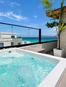 a hot tub on a balcony with a view of the ocean at Luxurious Ocean View Penthouse in Boca Chica +31 photos