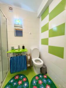 a small bathroom with a toilet and a sink at Horta Joy! in Horta +17 photos