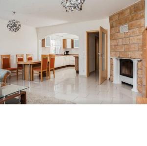 a kitchen and dining room with a table and a fireplace at Zimmervermietung Aras in Paderborn
