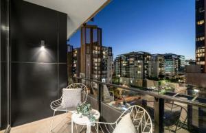 a balcony with two chairs and a view of a city at City Vibe on Dorcas Southbank in Melbourne +8 photos