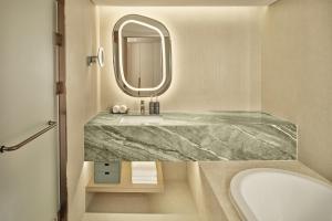 a bathroom with a marble sink and a mirror at The Westin Seoul Parnas in Seoul