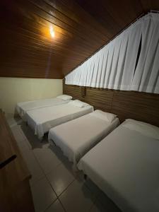 a room with three beds and a window at Flat Monte Castelo Gravatá - Pe in Gravatá +68 photos