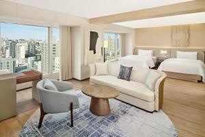 a hotel room with a couch and a bed at The Westin Seoul Parnas in Seoul
