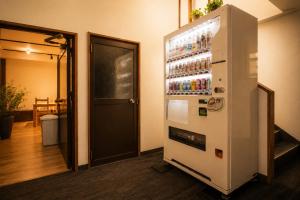 a refrigerator with drinks in it in a room at nozawasnow in Nozawa Onsen