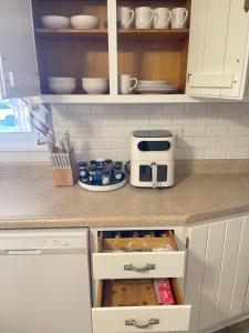 a kitchen with a counter with a coffee maker on it at Xuan Pine House in Altoona +3 photos