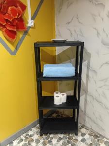 a black shelf with towels on it in a room at Tereva home 1 in Bora Bora