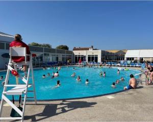 a group of people swimming in a swimming pool at Dollys Den in Pagham